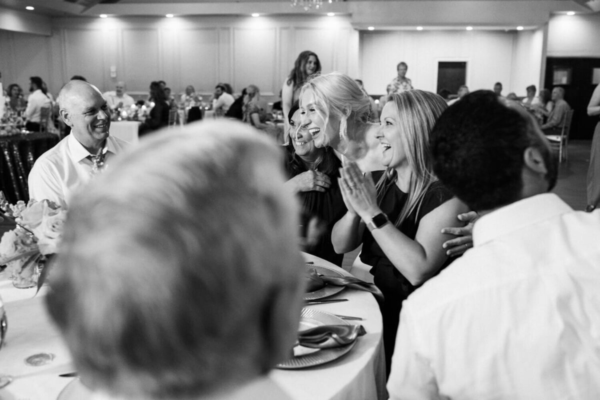 bride-hugging-women-seated-at-table