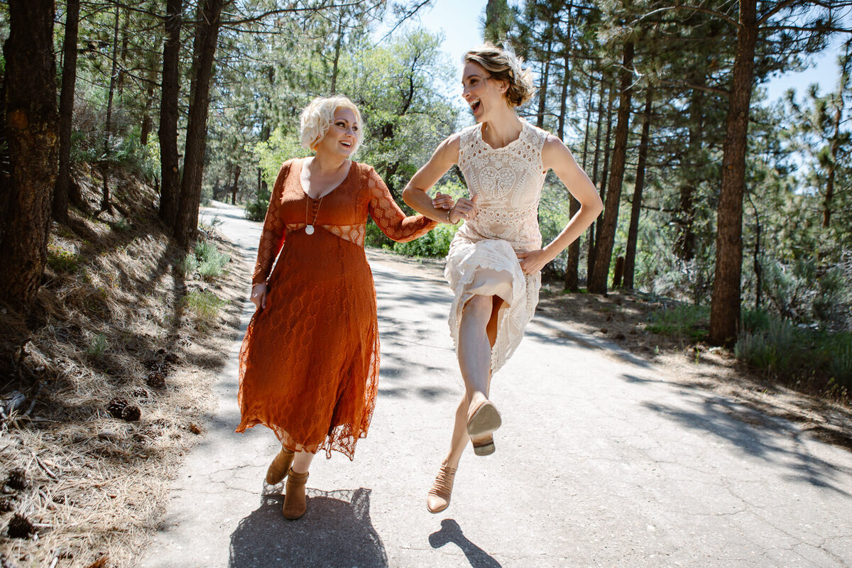 Two people skip outdoors having fun.