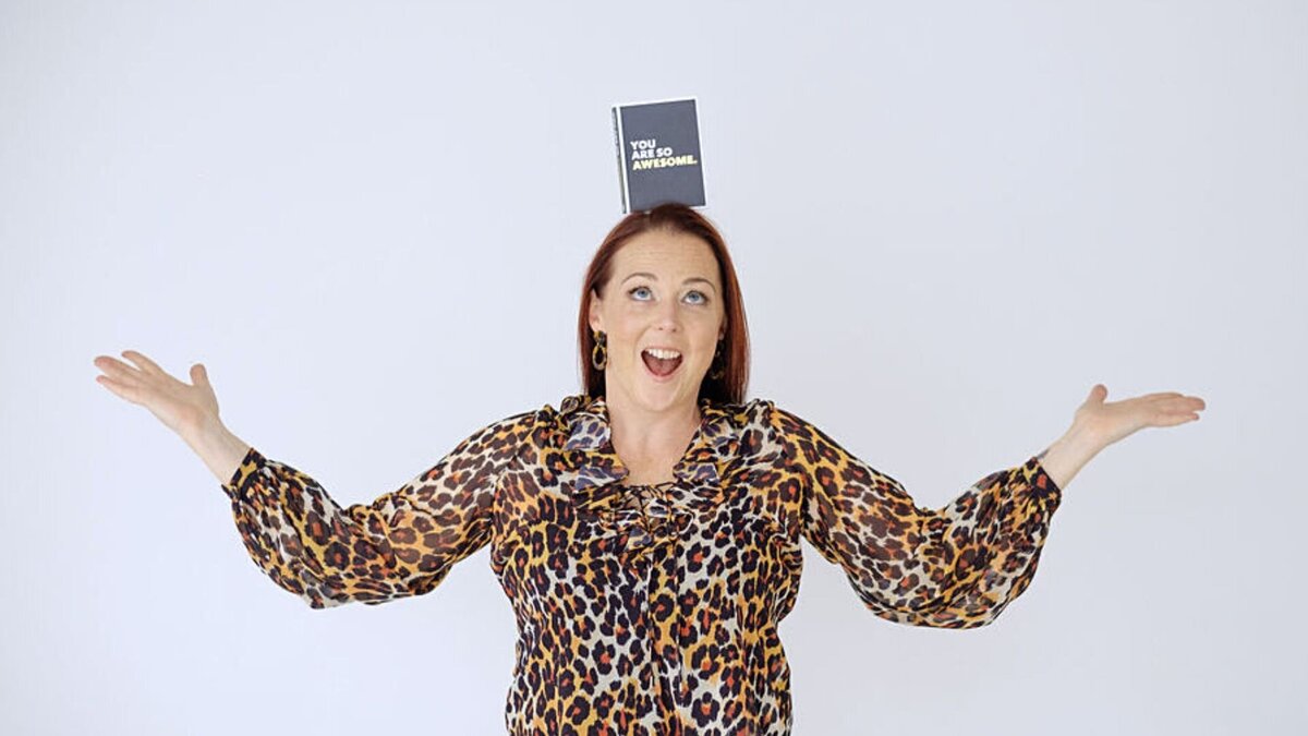 Positioning coach Hayley Maxwell with a book balanced on her head that says You are so awesome