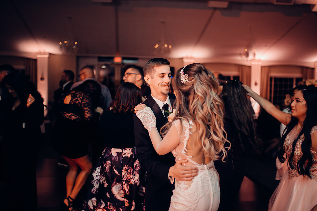 Wedding Photograph Of Groom Holding His Bride At The Waist While Dancing In The Middle Of The Crowd Los Angeles