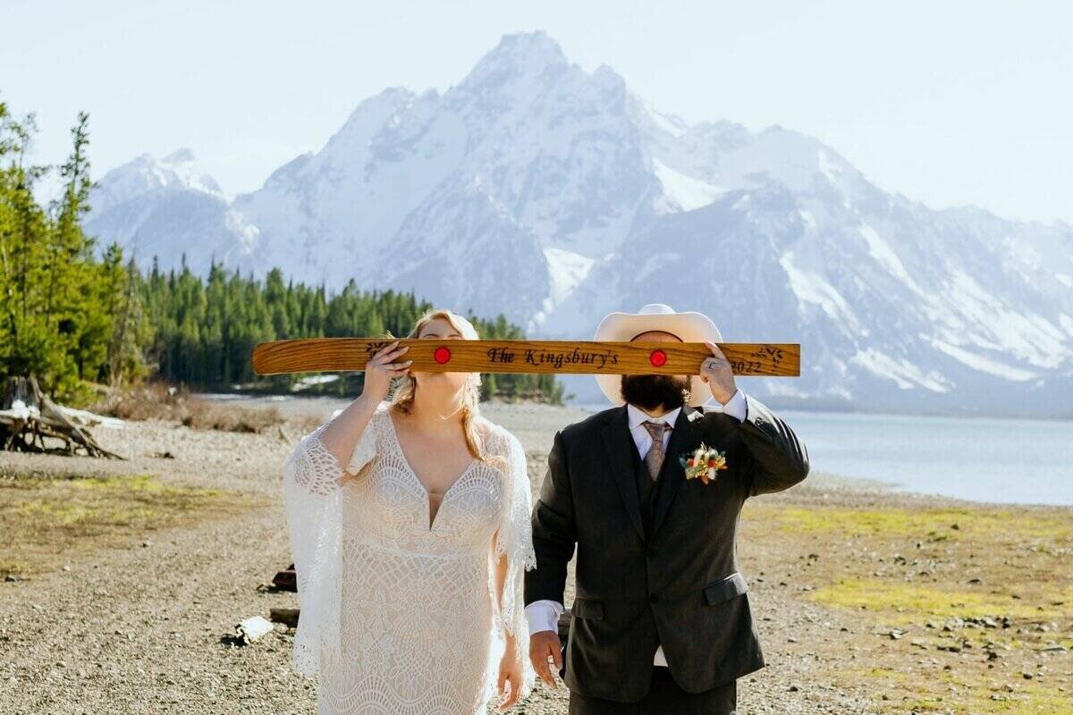 bride and groom share a shot ski at the end of their wedding at colter bay