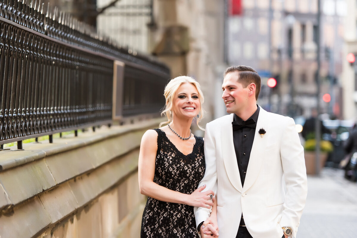married couple posing for photo on sixth avenue in pittsburgh