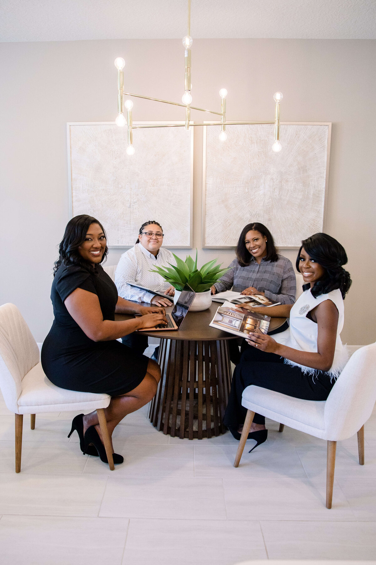 commercial photographers captures four business women sitting around a table in an office space planning in a business meeting