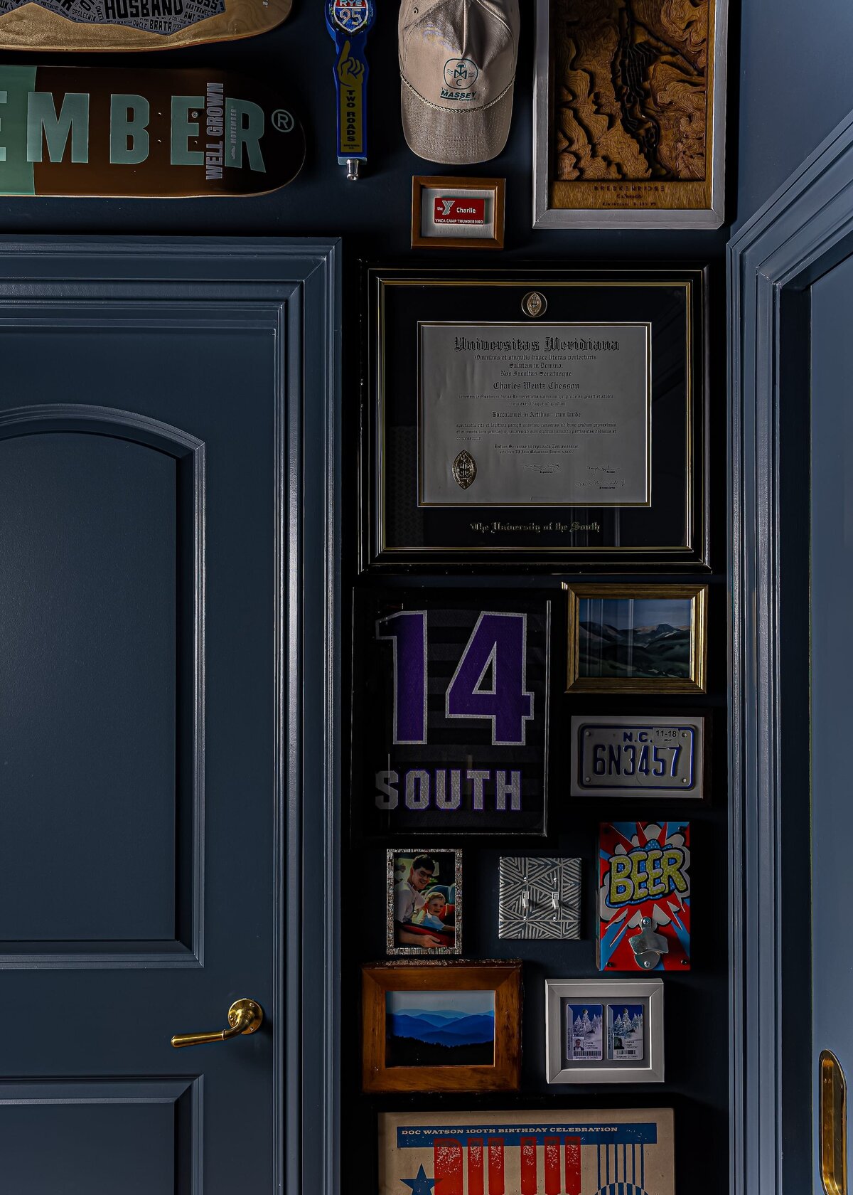 melinda chesson interiors carriage house moody blue wall with hanging frames