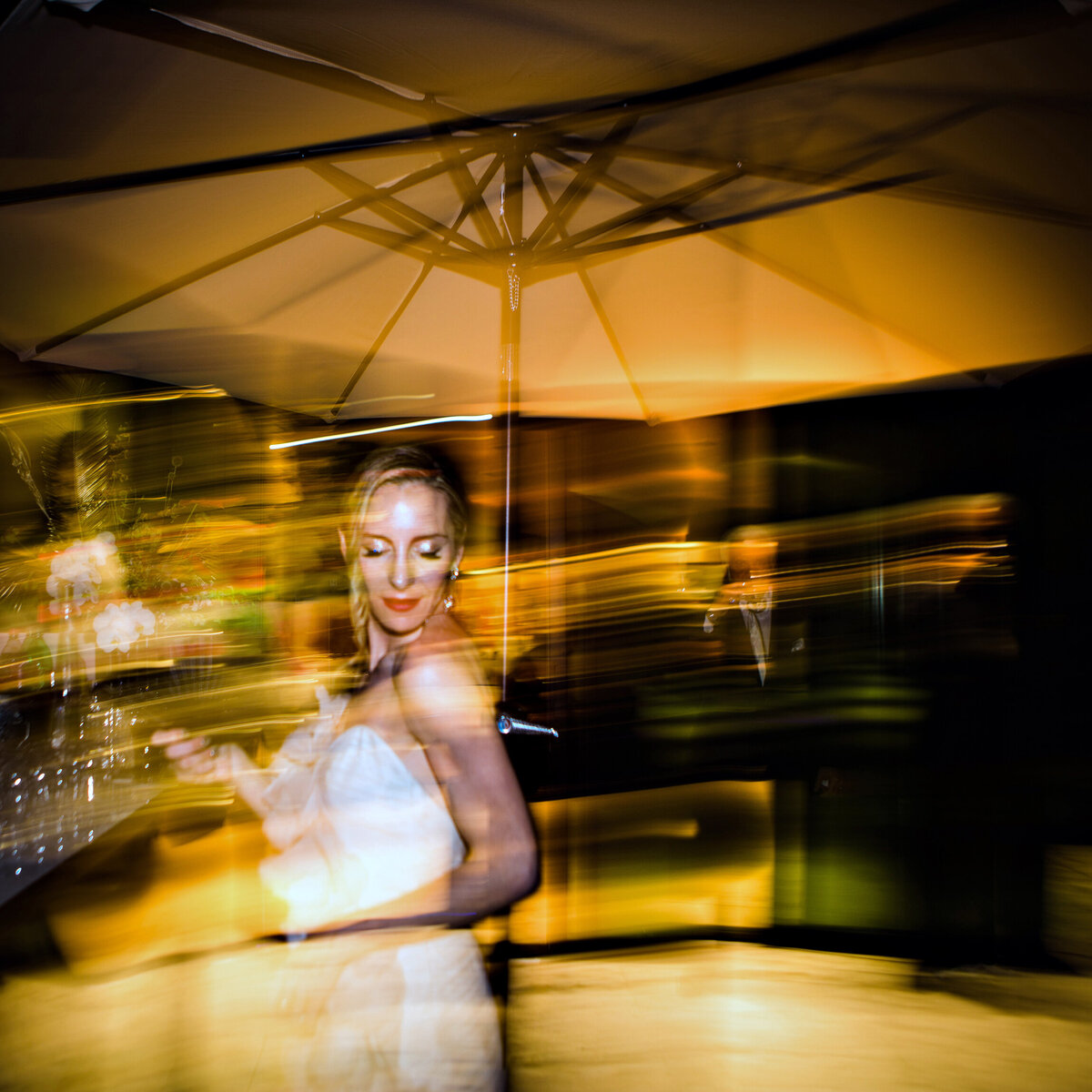 Blurry image of bride dancing at wedding reception