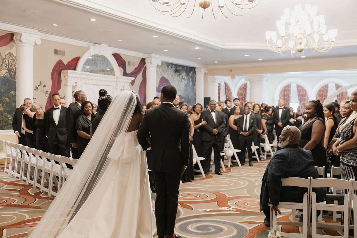black wedding ceremony bride walking down aisle