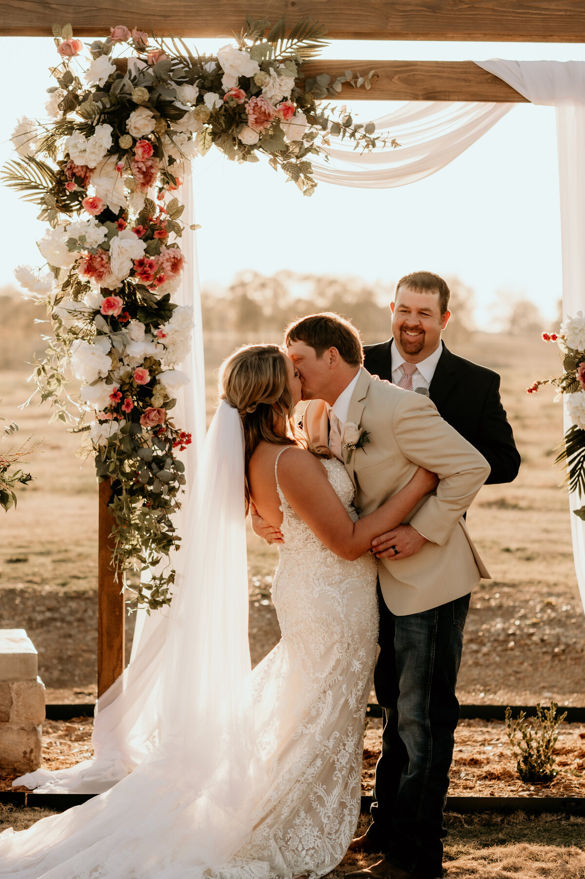 sunset wedding with bride and groom sharing their first kiss after they say their I-dos