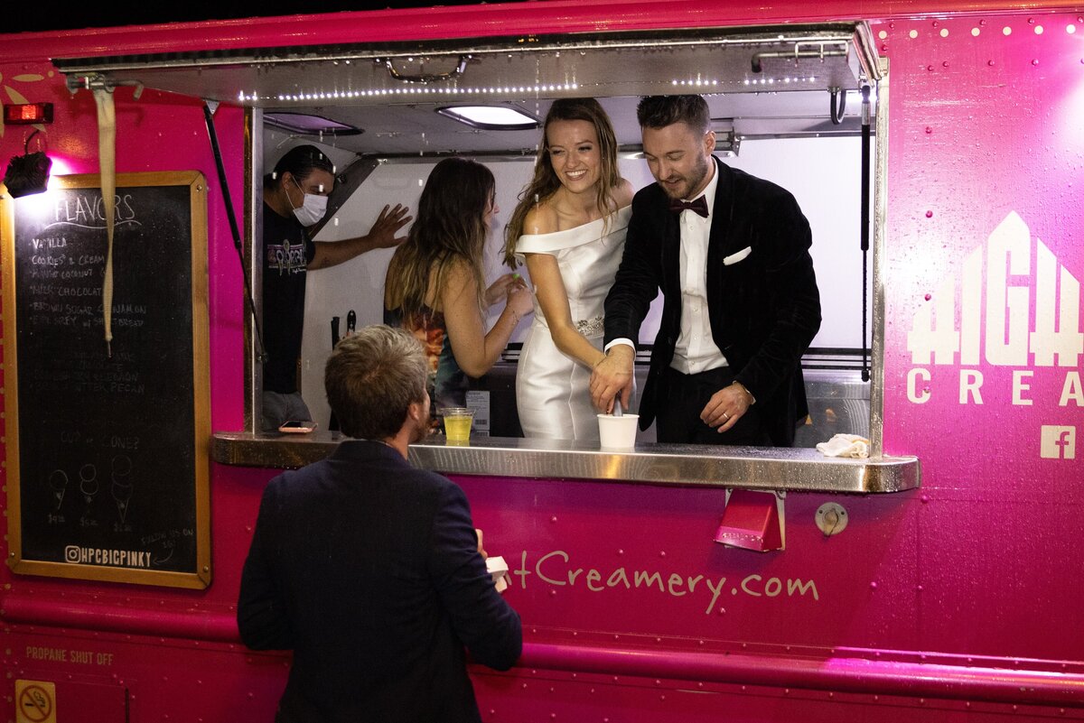 Bride and groom serve their guests ice cream from the  High Point Creamery truck at their wedding reception.