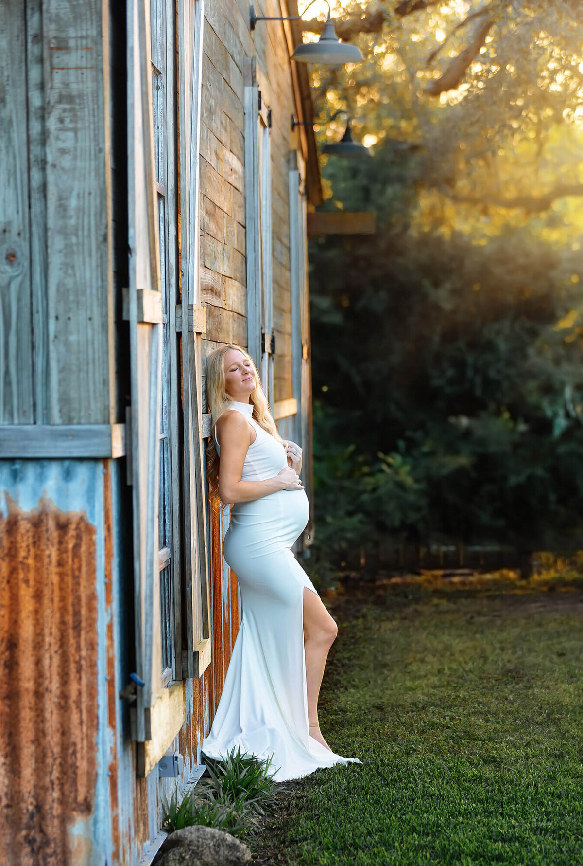 Stunning pregnant woman wearing a white dress photographer during golden hour by Texas photographer Danielle Dott Photography.