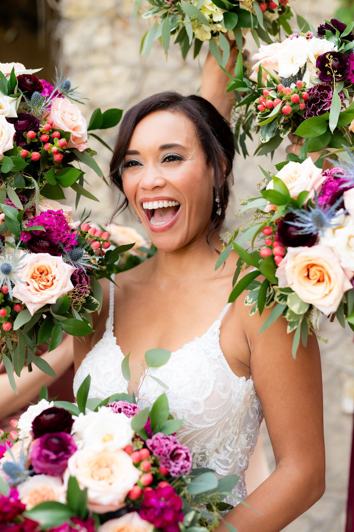 bride surrounded by colorful wedding bouquets
