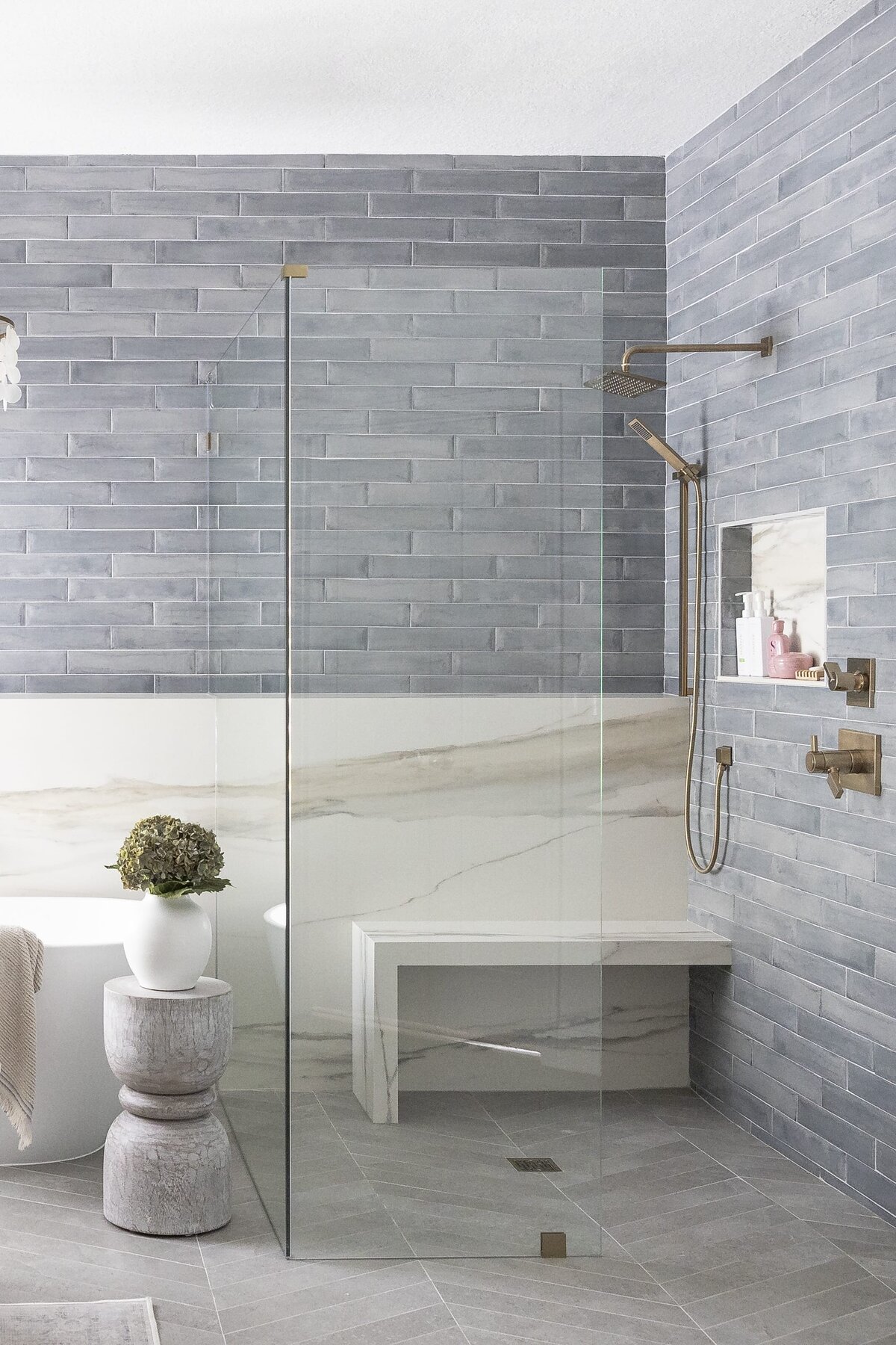 dewine design orlando interior designer contemporary coastal primary bathroom large shower with glass and marble shower seat