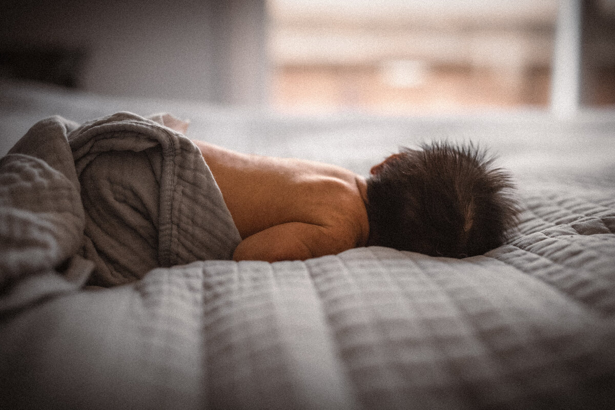 newborn baby on bed