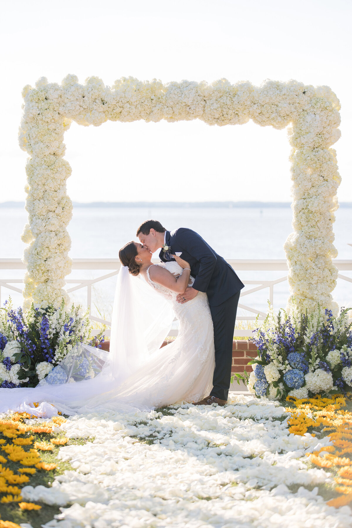 Chesapeake Bay Beach Club wedding ceremony at Beach House Ballroom with floral arch by Christa Rae Photography