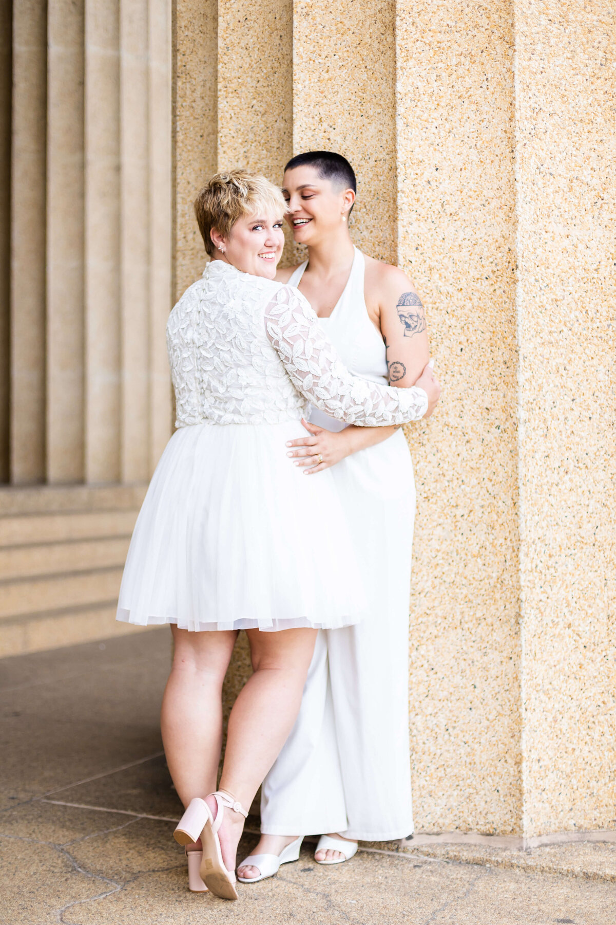 Gay couple hugging at LGTBQ wedding in Centennial Park, Nashville,TN