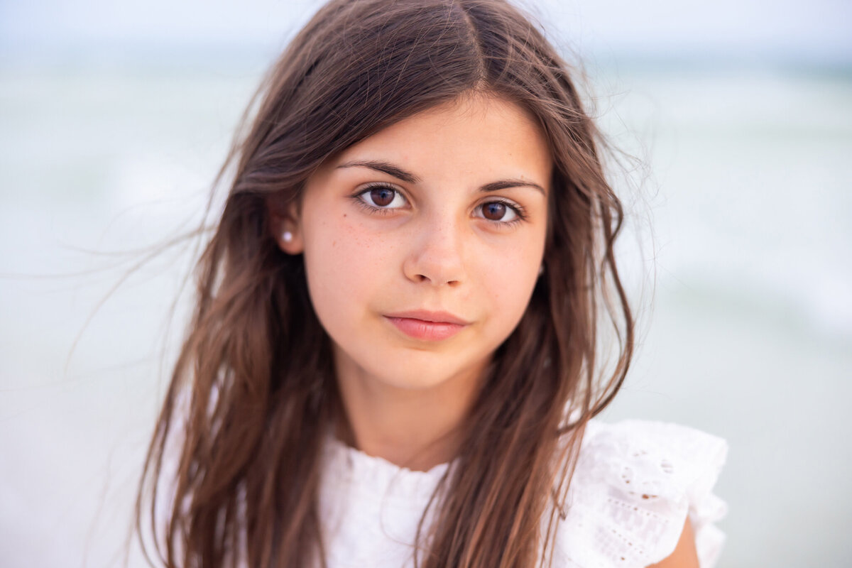 close up of a girl with dark hair and dark eyes on the beach of 30a.