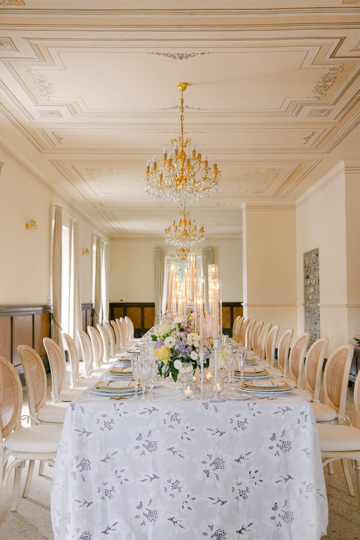A wedding day photo of the reception cable covered in linens and candles at the wedding venue Villa Aura del Lago on Lake Como in Italy
