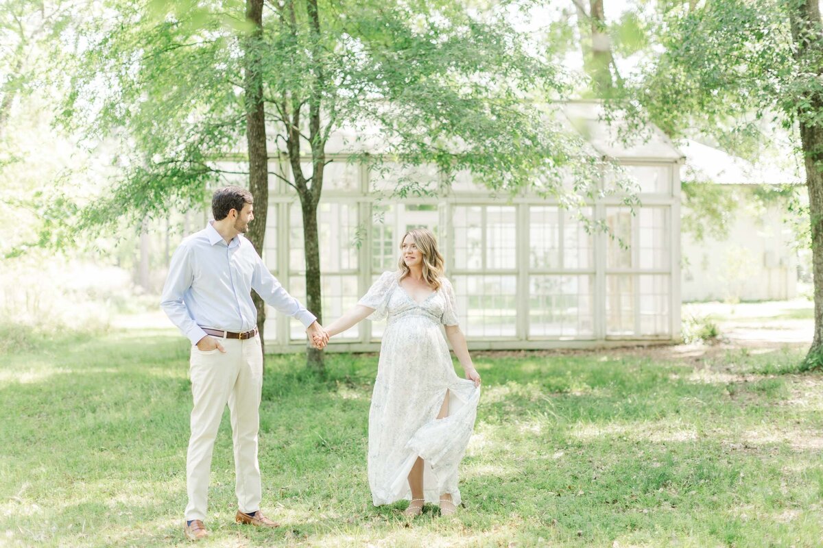 Couple walks through houston scenic woods for family photos