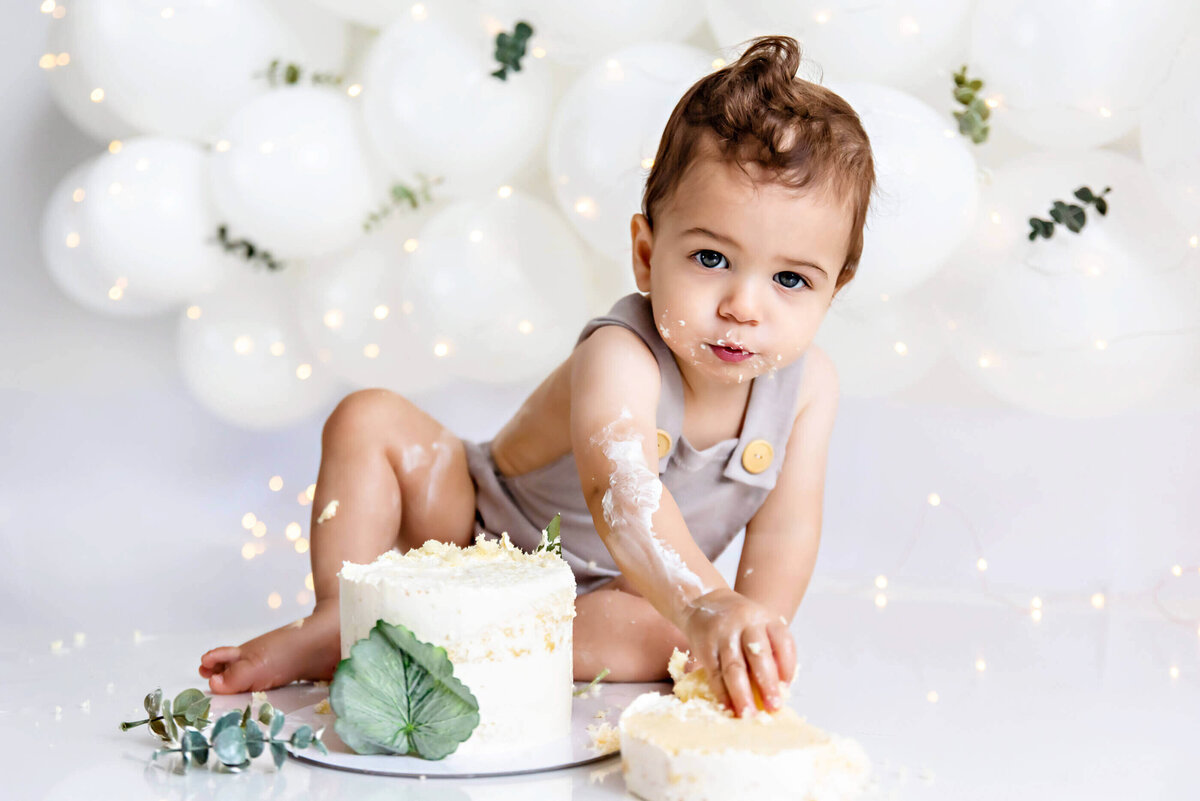 little boy with his cake for his Burlington cake smash photographer session