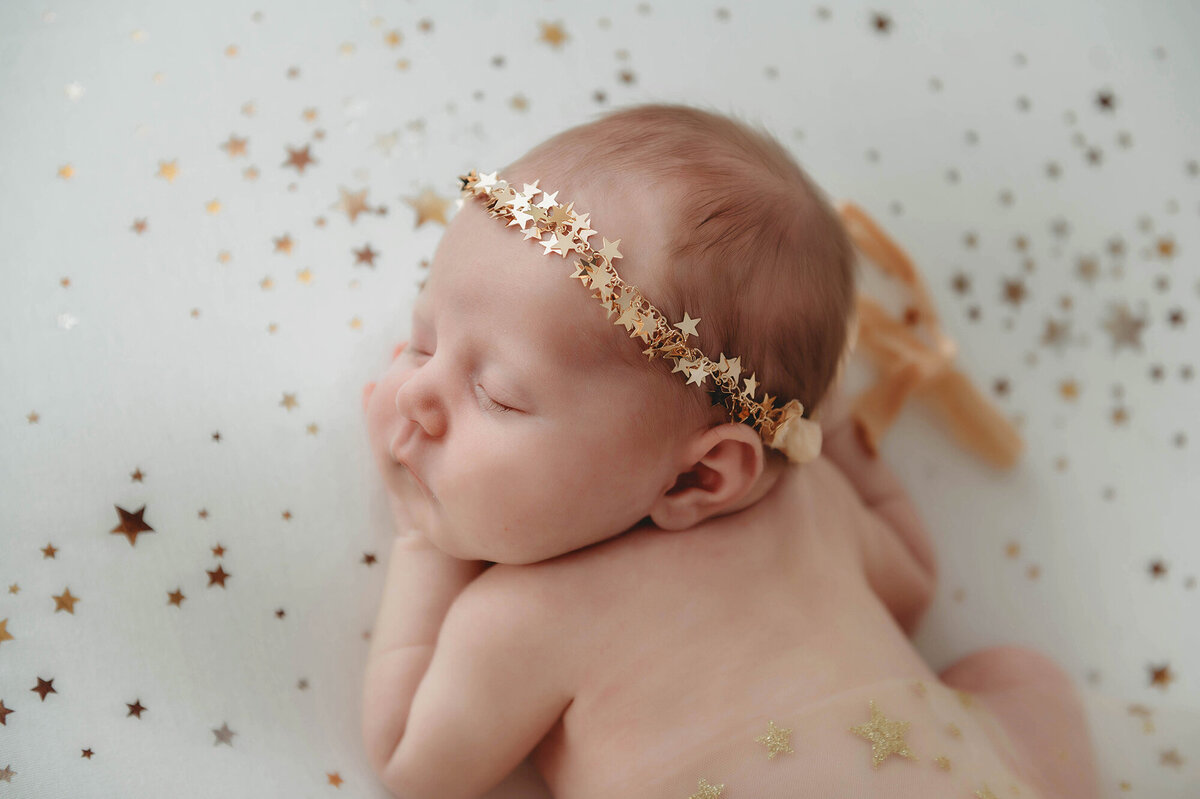 Best Baby Photographer in Charleston, SC poses Infant for Newborn Photoshoot.