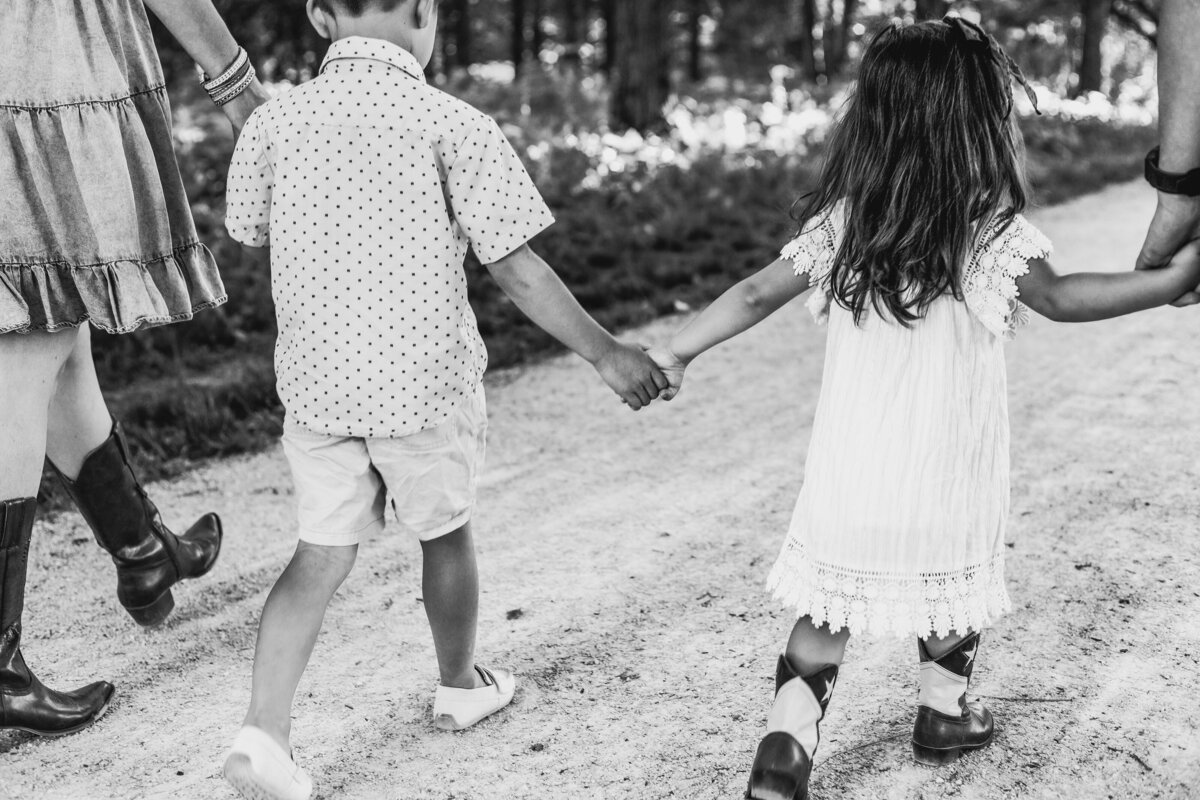 Siblings holding hands.