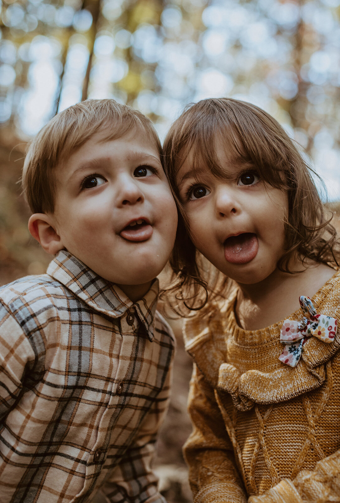 4 year old twins make a silly face at the camera 