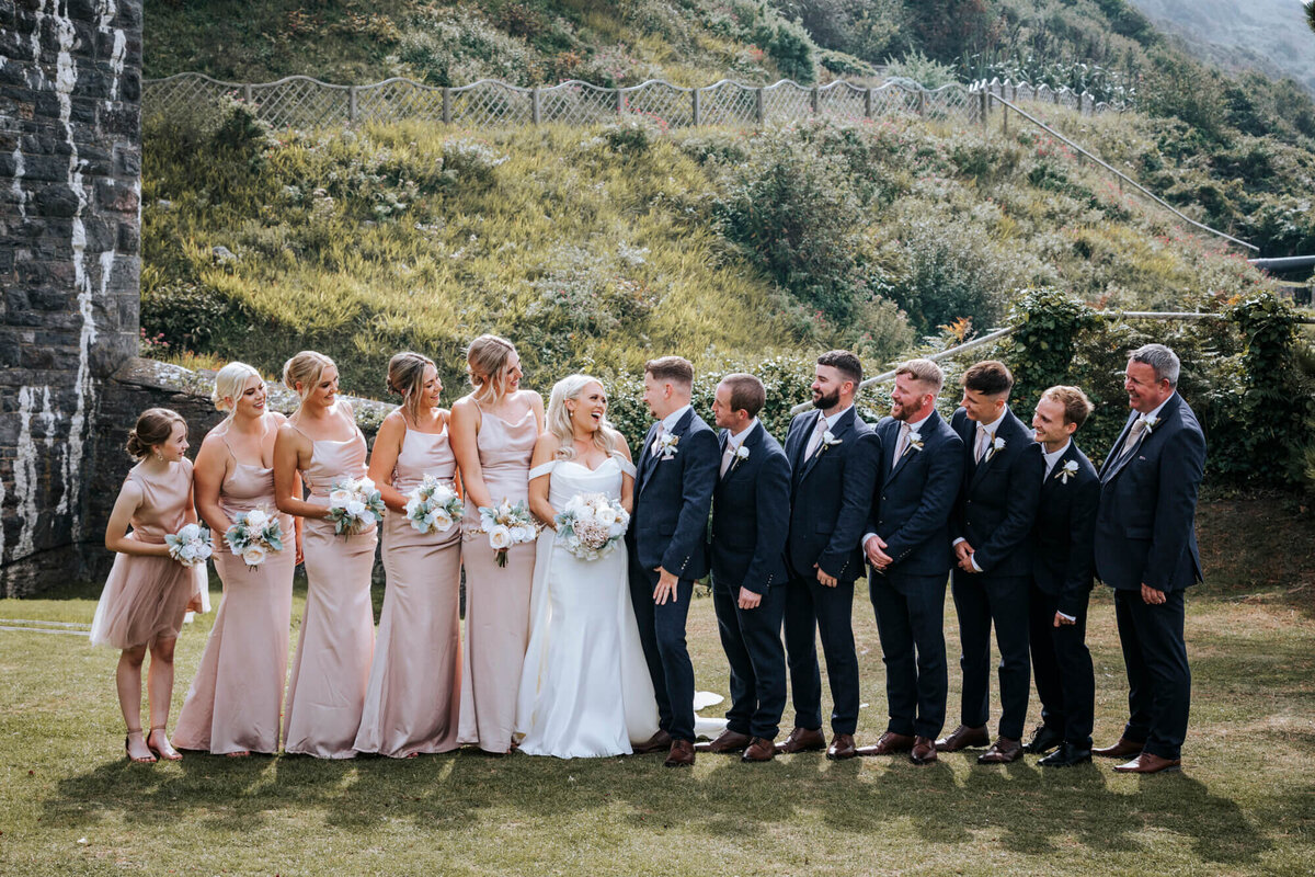 A group photo of the bridesmaids and groomsmen with the bride and groom