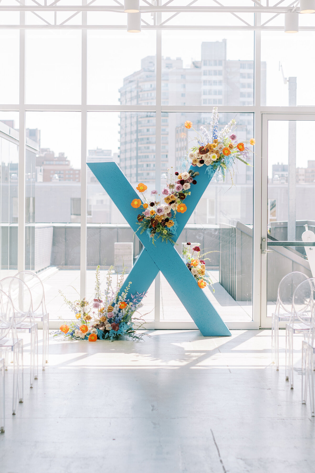 An installation of colourful modern flowers at a wedding ceremony overlooking downtown Montreal.