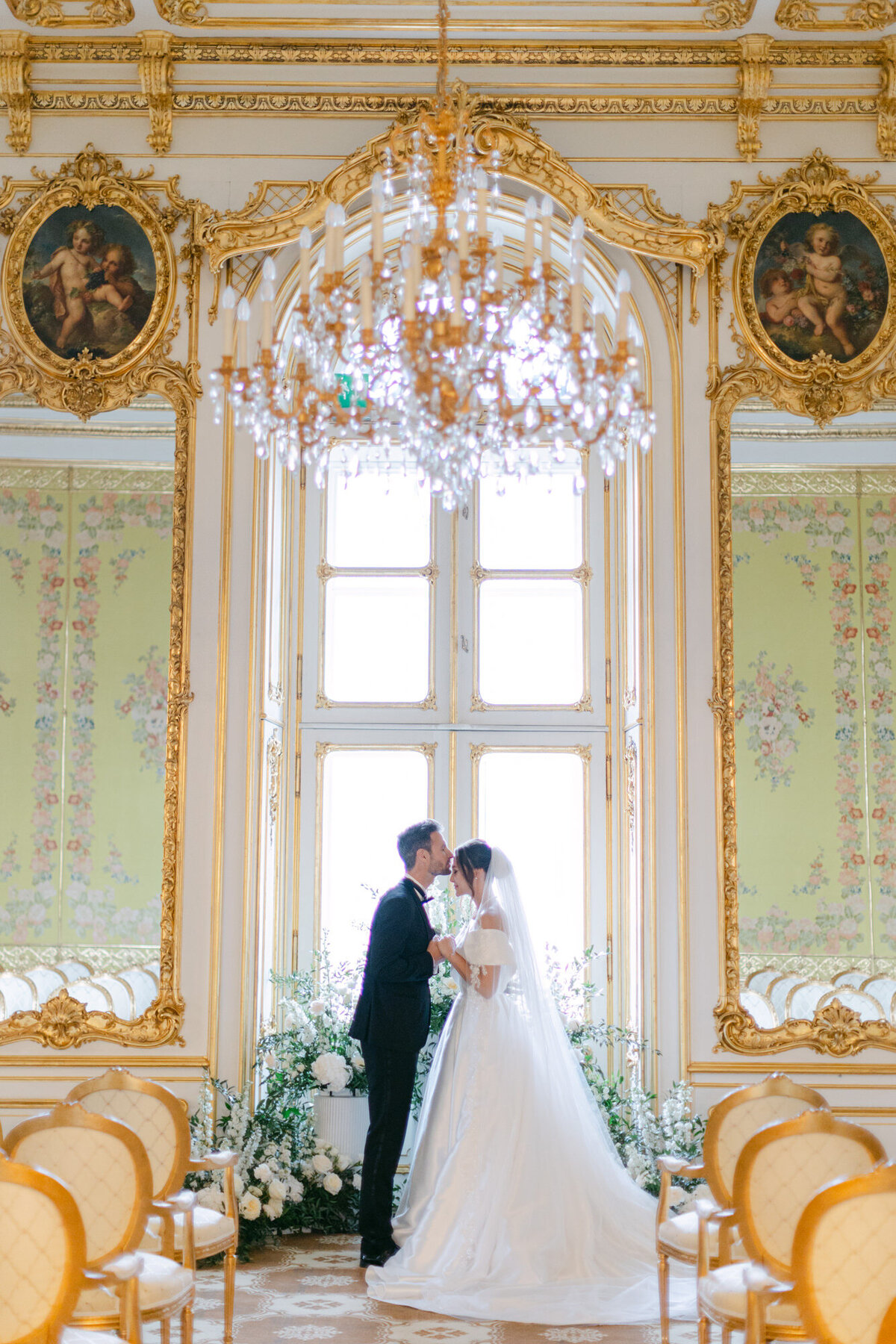 Wedding couple kissing at the ceremony in luxury palace Coburg in vienne