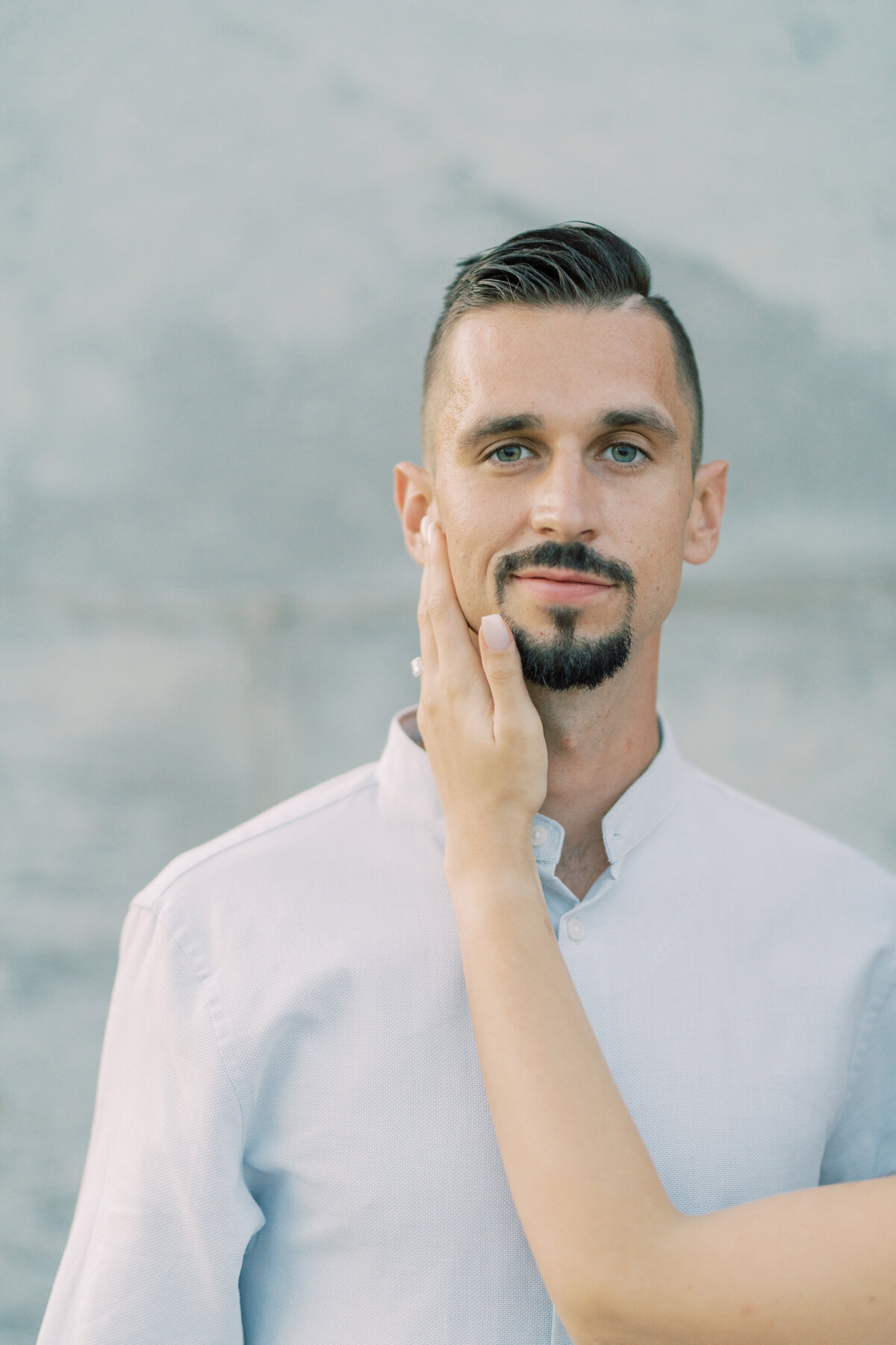 Groom’s serene expression as his fiancée lovingly rests her hand against his cheek, captured at Toronto’s RC  Harris Water  Treatment Plant