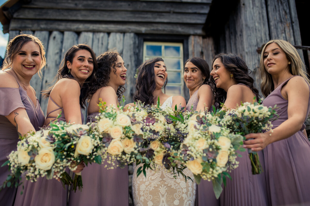 bridesmaids smiling with flowers