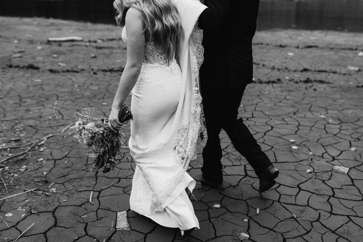 Couple holding hands and going for a walk during their adventurous elopements on a mountain at Maroon Bells Colorado