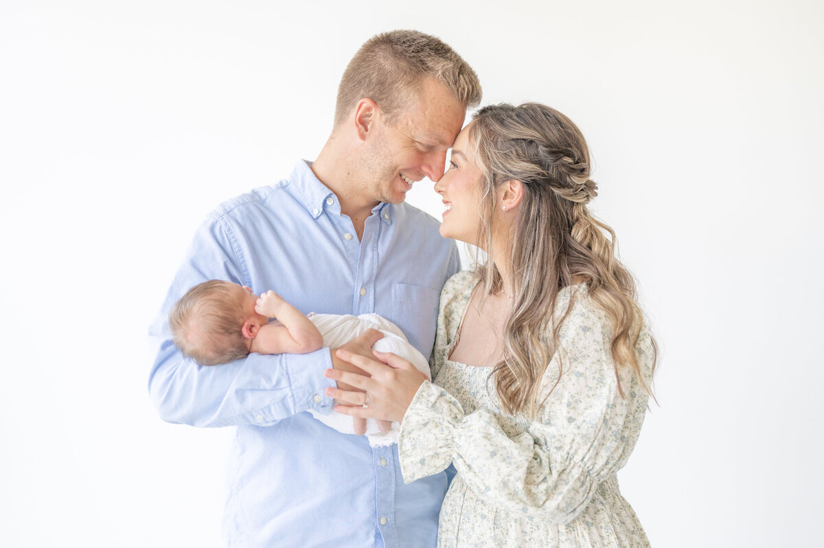 Mom dad and baby by Raleigh Newborn Photographer
