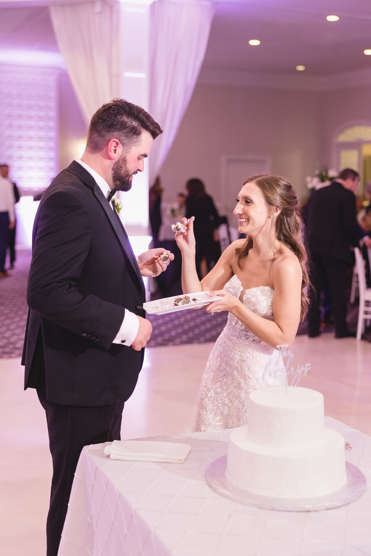 A bride and groom cut their wedding cake