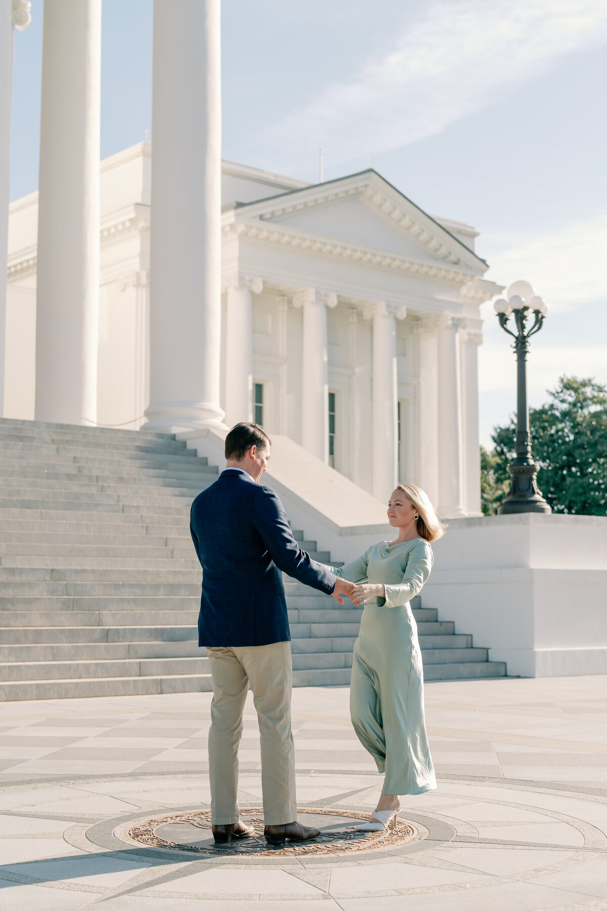 Engagement Photos at the Virginia Capitol Building | Engagement Photographer in Richmond VA | engaged couple dancing in front of the steps of the Virginia Capitol Building in downtown Richmond VA