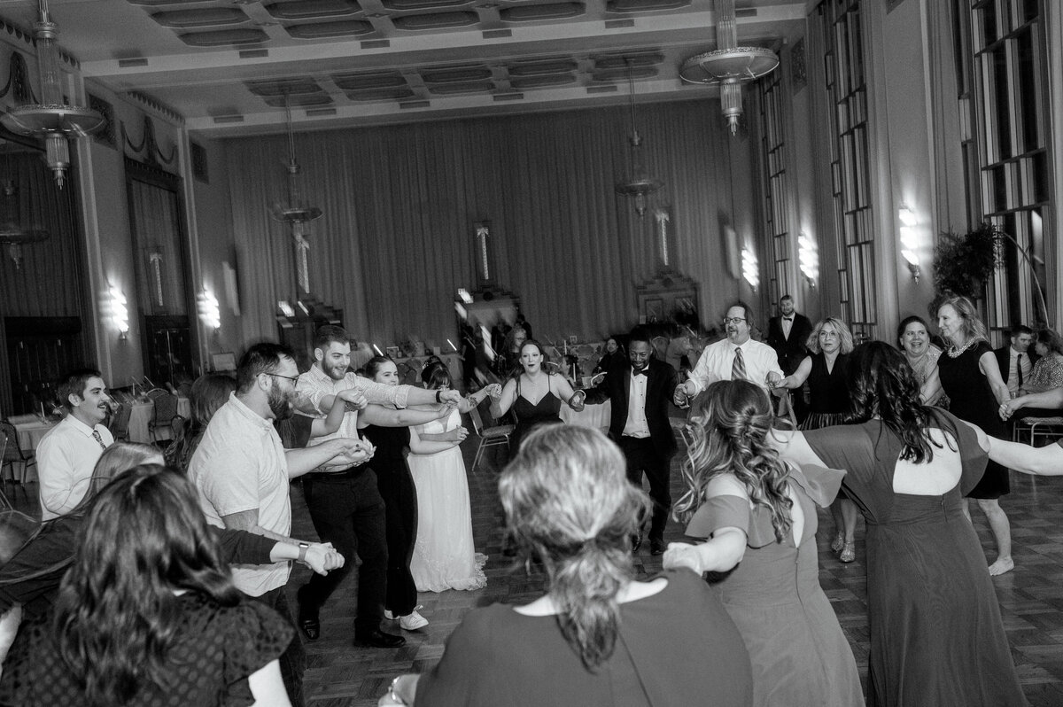 Guests dance together at a wedding reception.