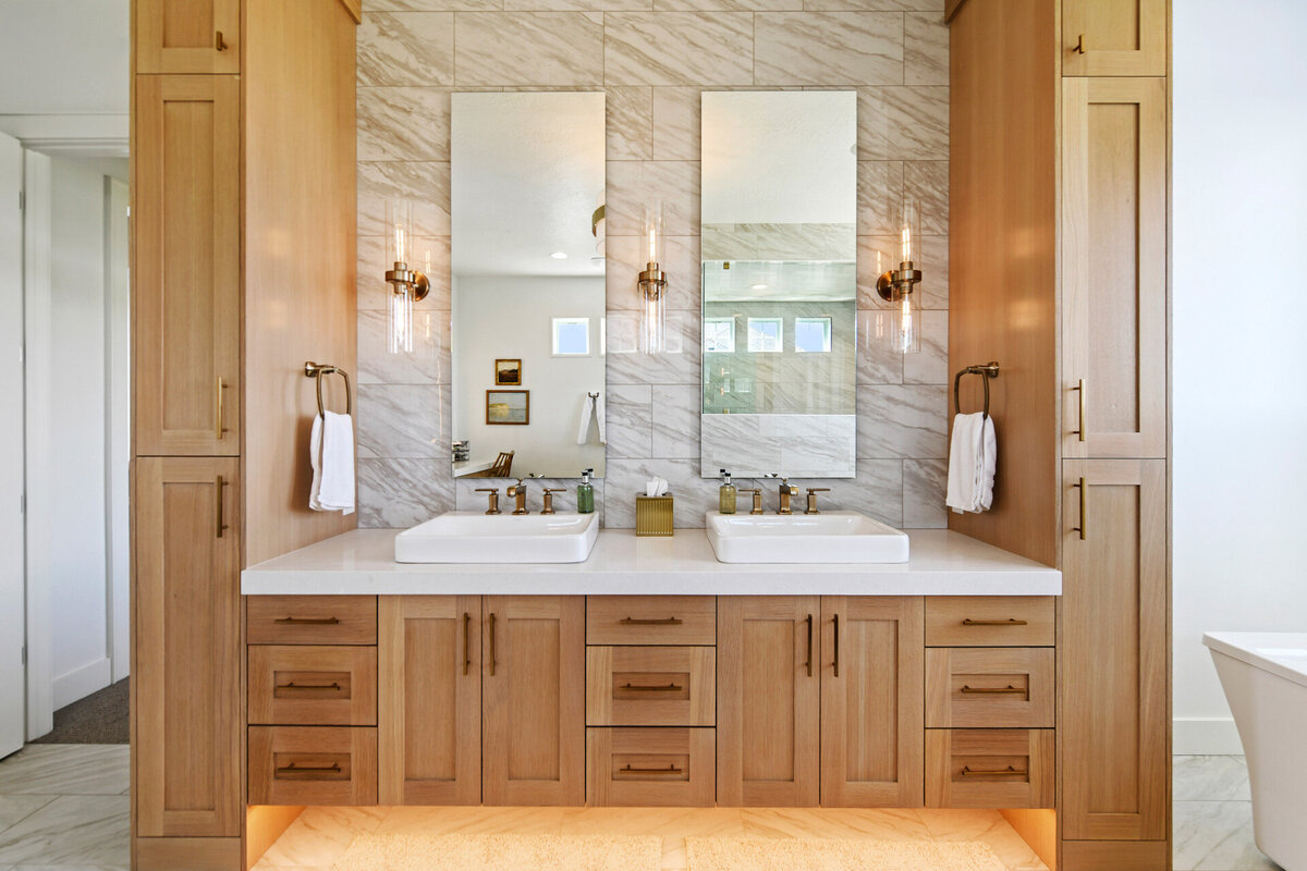 custom bathroom with wood cabinets and luxury lighting by Idaho luxury custom home builder Thompson Homes