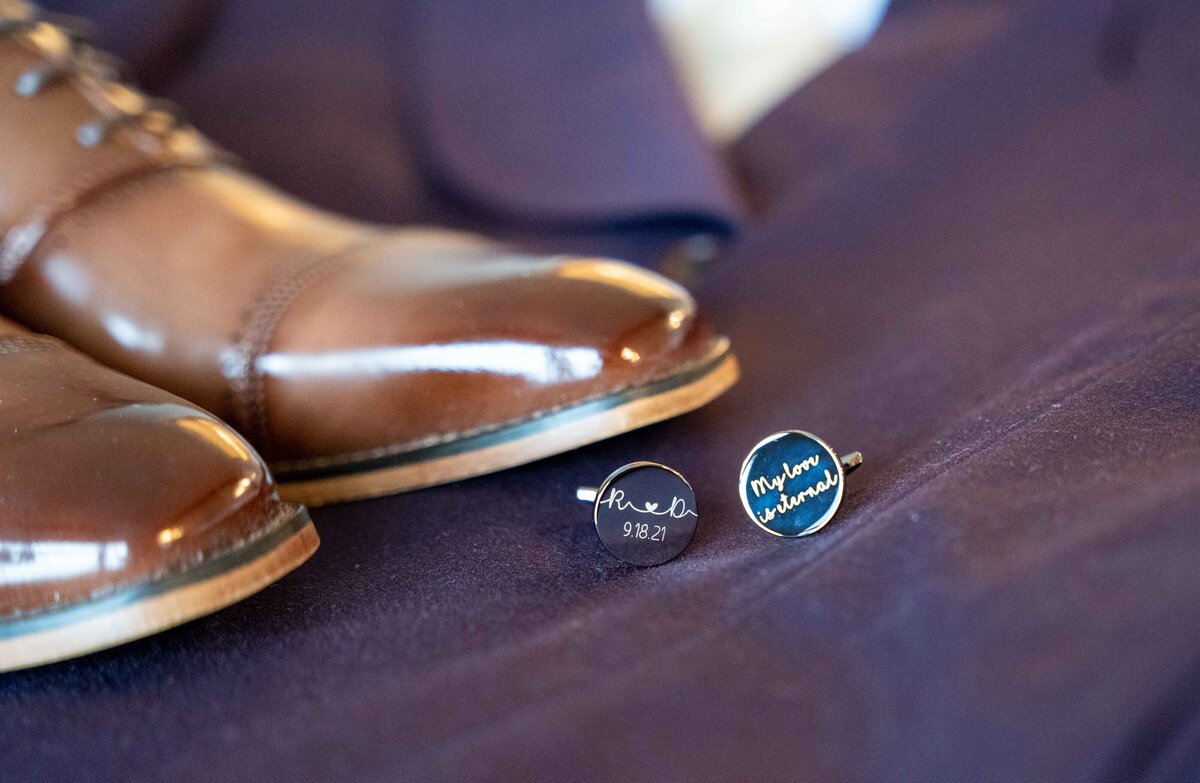 A groom's purple suit with custom cufflinks lay on the bed at the InterContinental Washington D.C.