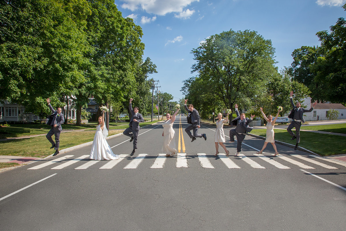 wedding party walking across like Abbey Road on crosswalk