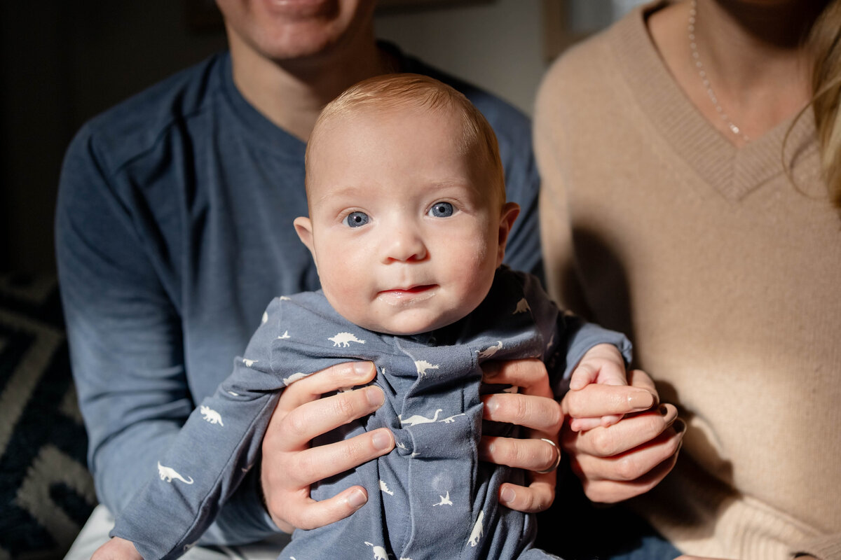 Baby boy in pjs in mom's arms