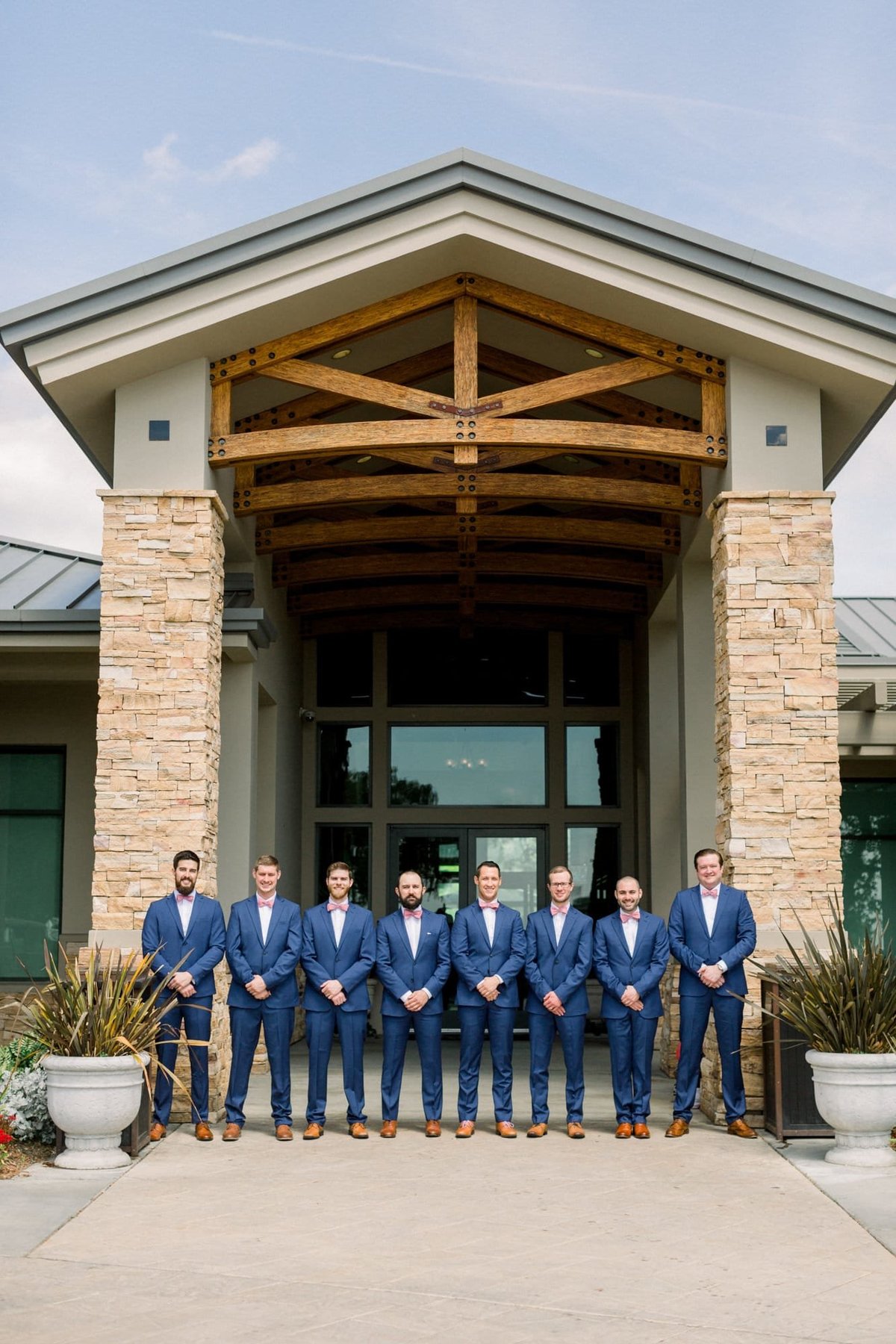 Groom poses with his groomsmen for photos