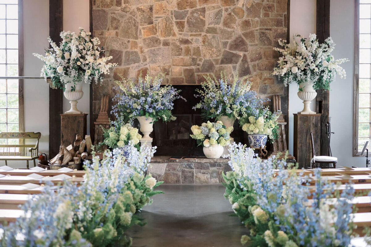 A beautiful wedding aisle is adorned with lots of flowers at The Lion Rock Farm, CT. Image by Jenny Fu Studio