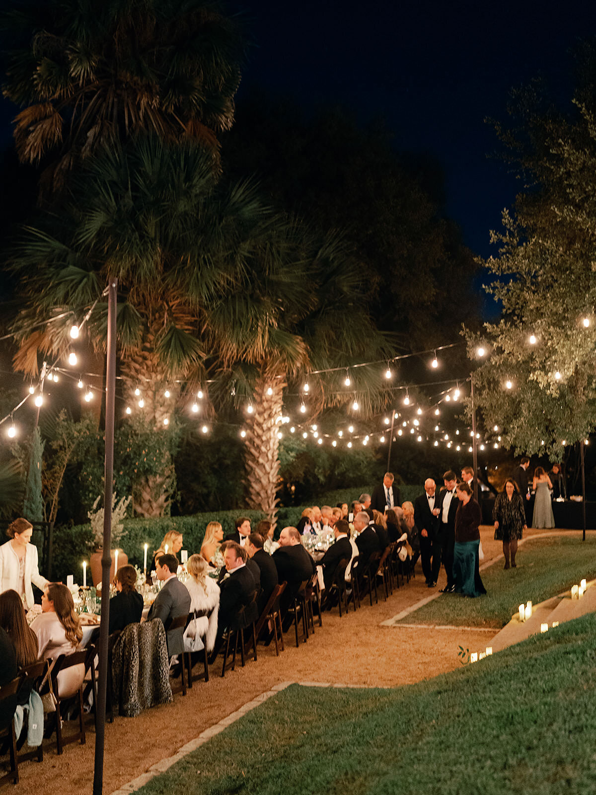 An intimate wedding reception lit by bistro lights at Laguna Gloria