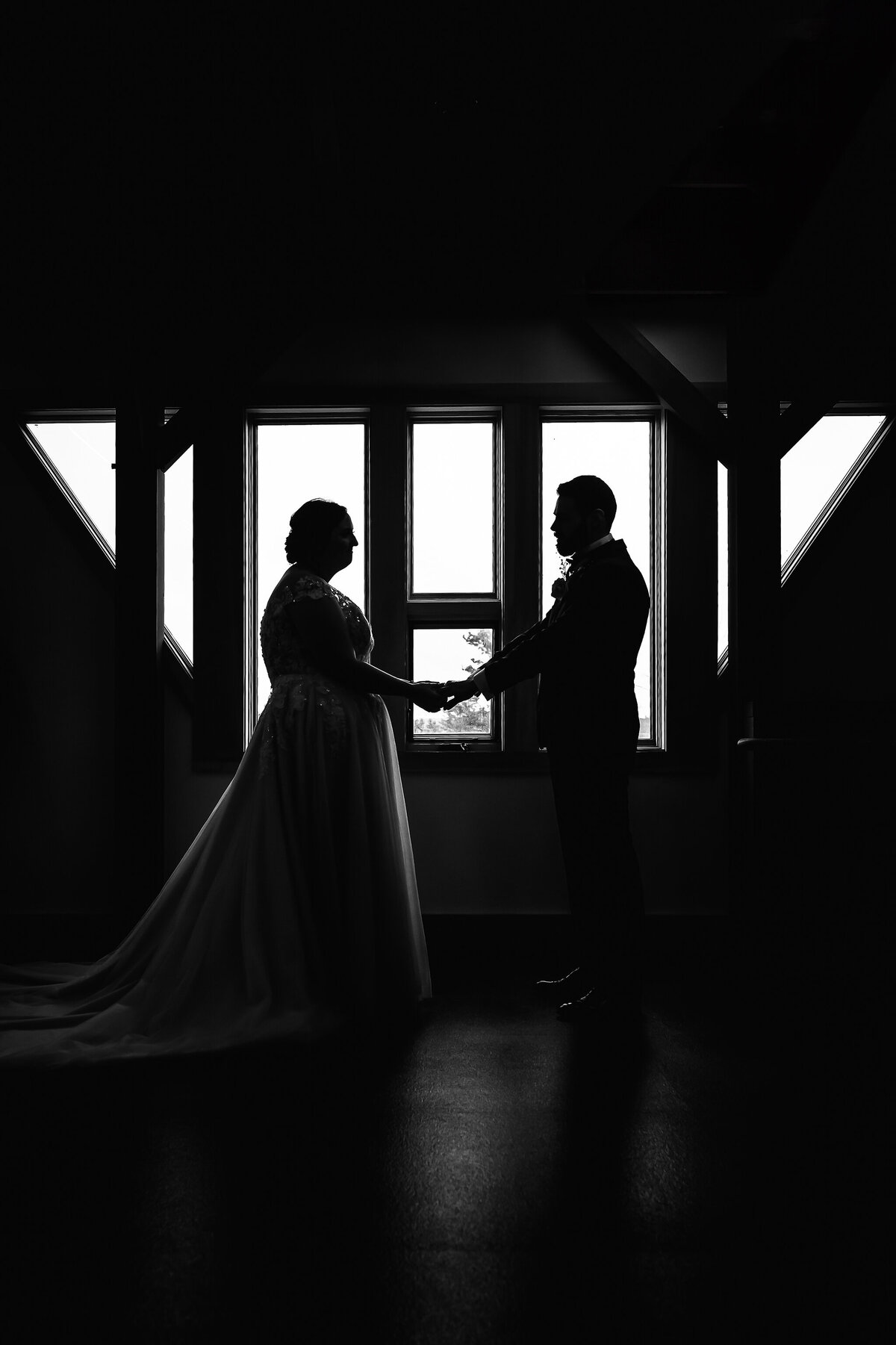 bride and groom reading vows in front of triangle window at Pats Peak wedding