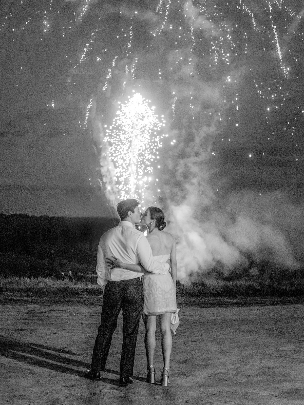 Bride and Groom Kissing with Fireworks