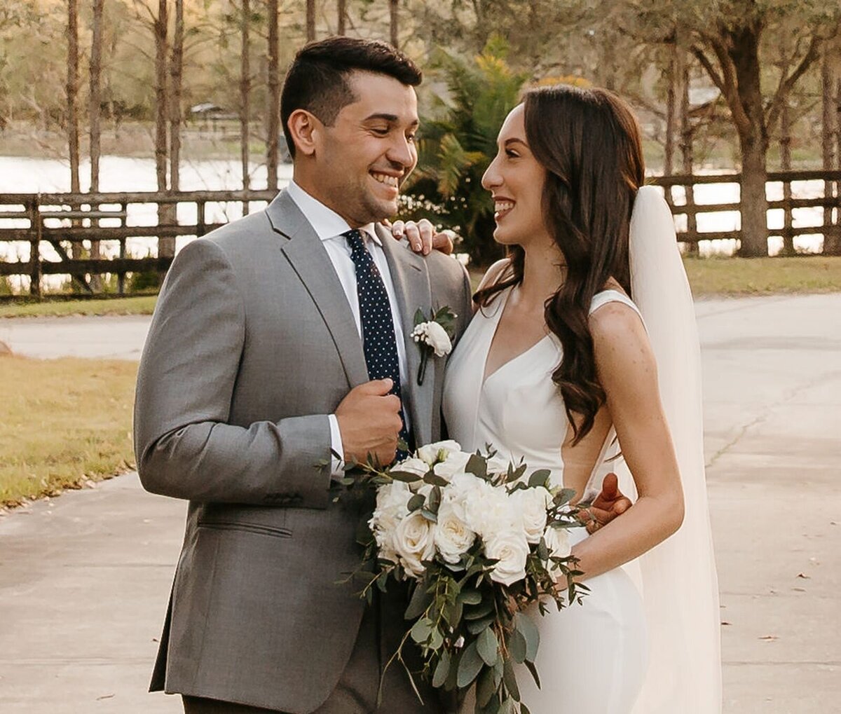 Groom and bride smiling at each other at Club Lake Plantation in Apopka, Fl