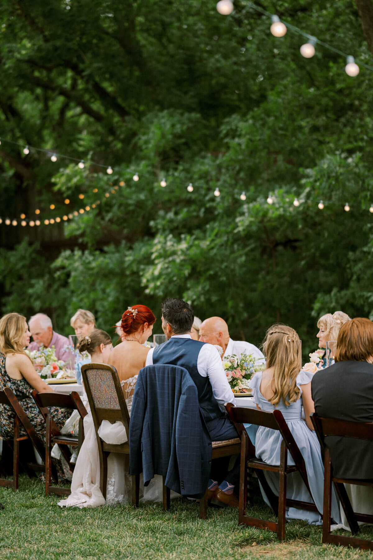 wedding-guests-dining-under-string-lights-outside