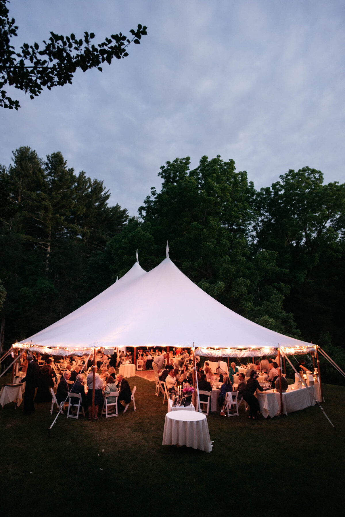 tented wedding glowing in the evening
