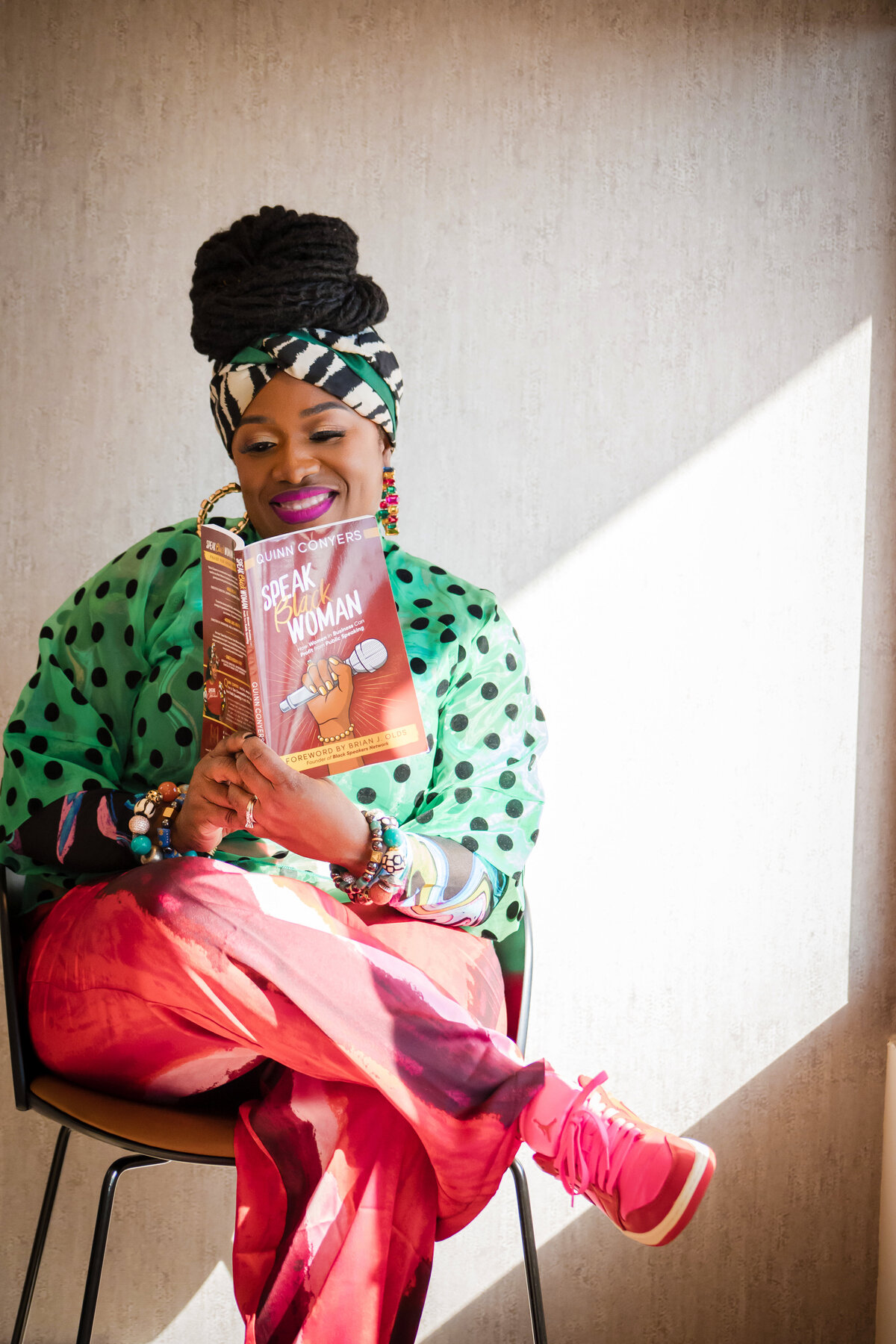 Creative lifestyle portrait photography by D3D Photography featuring woman reading book in colorful artistic setting with natural lighting