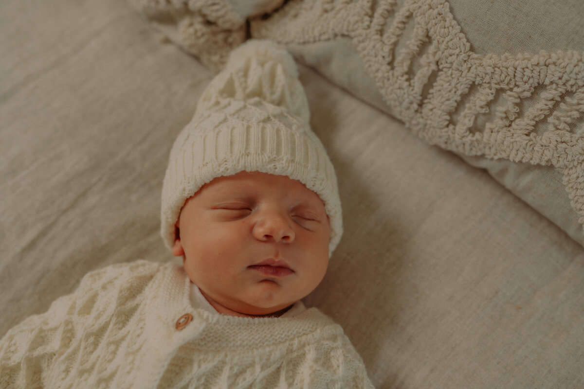 Baby ligt te slapen op het bed in de daglicht studio Antwerpen.
