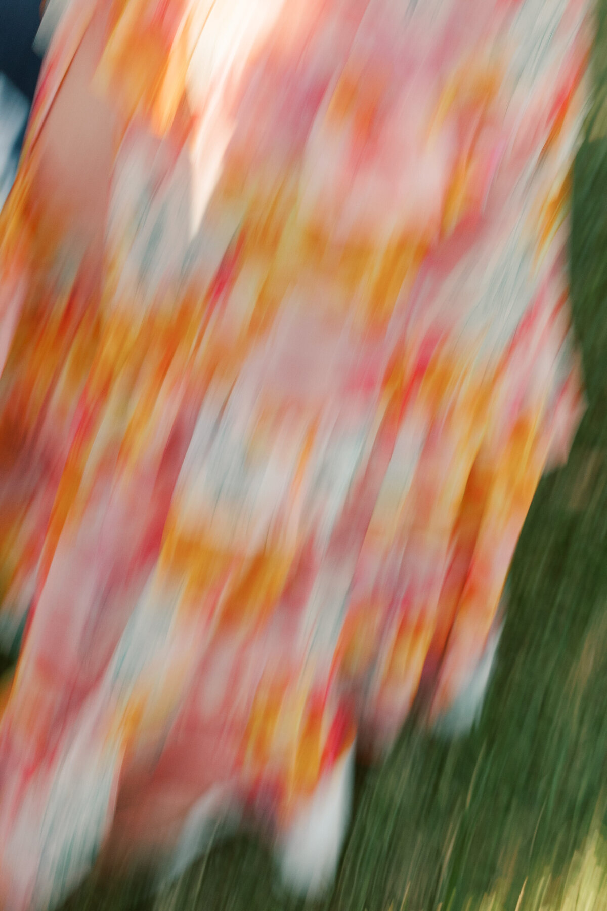 Blurred floral fabric moves in motion during the Cancun wedding, captured in vibrant detail by a Philadelphia photographer.